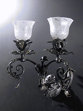 Pair of Wrought Iron Sconces with Leaf Formed Detail